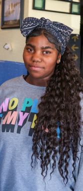 A young woman with a bow in her long hair.