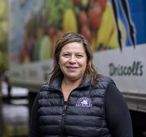 The CEO of Second Harvest Food Bank Santa Cruz standing in front of a delivery truck.